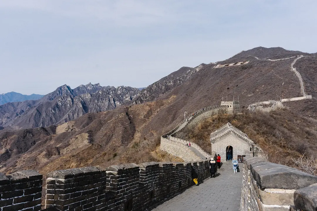 Mutianyu wall and watchtower in winter, with bare brown mountains behind